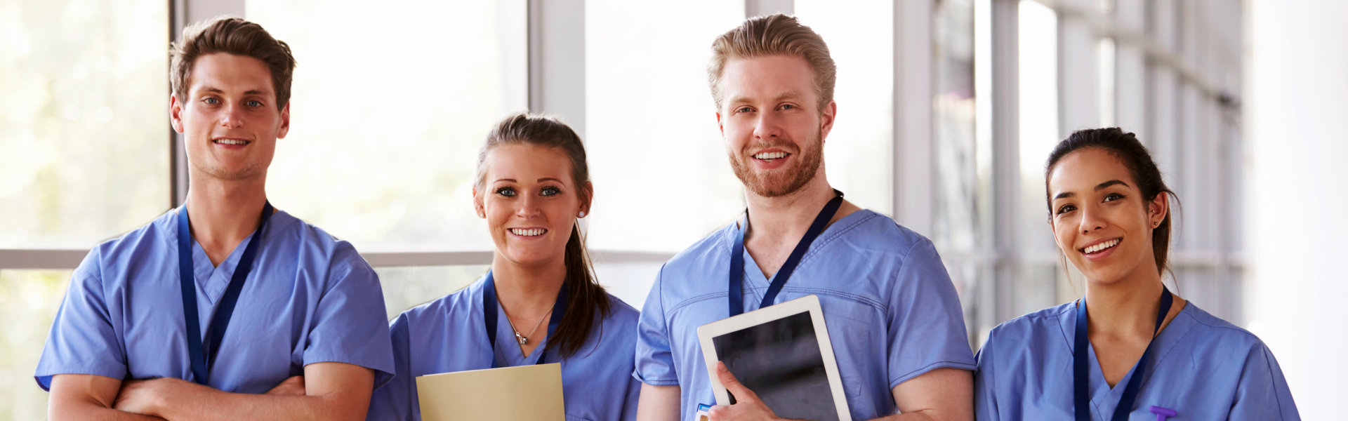 Group portrait of healthcare workers in hospital corridor